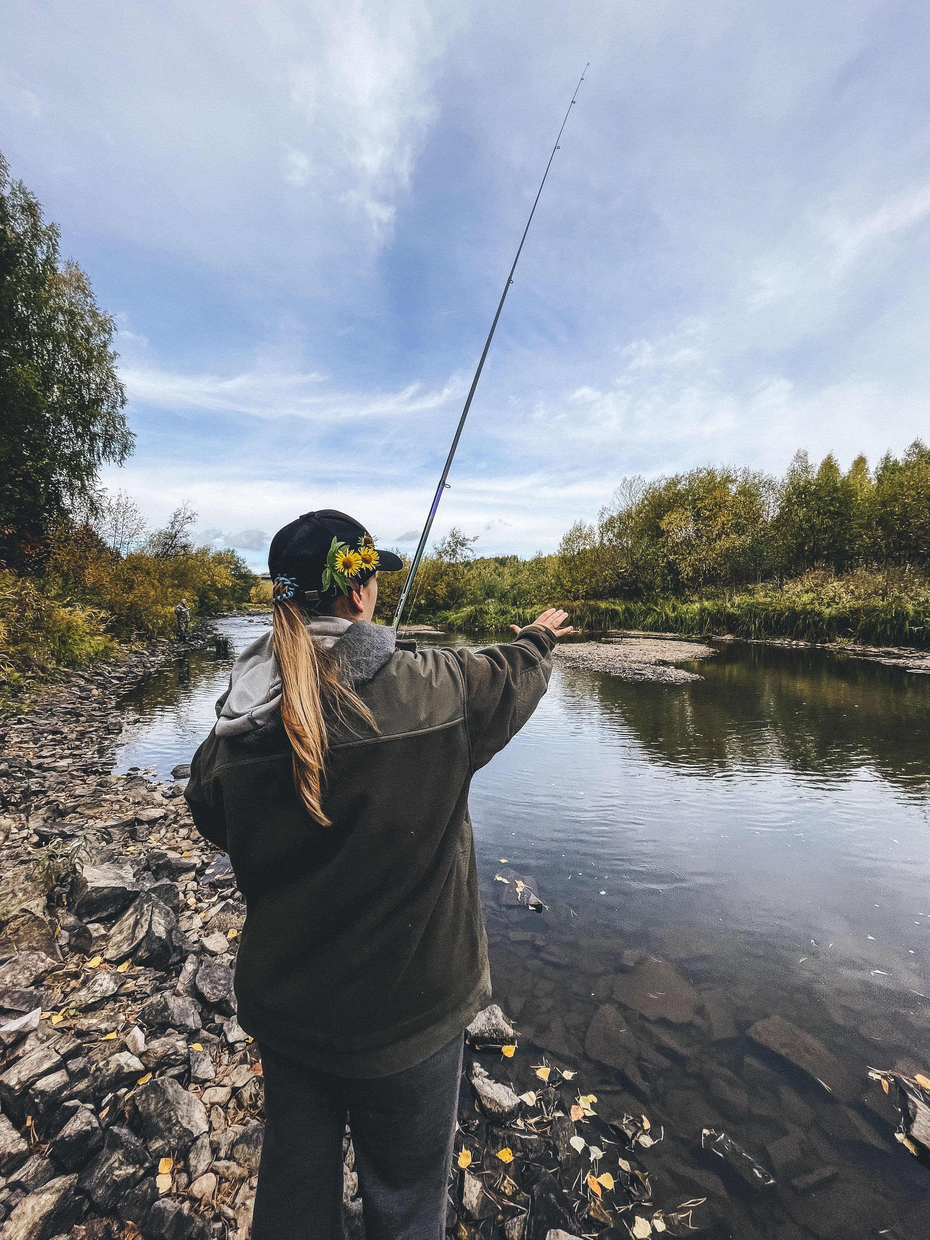 Angler casting into a rocky autumn river